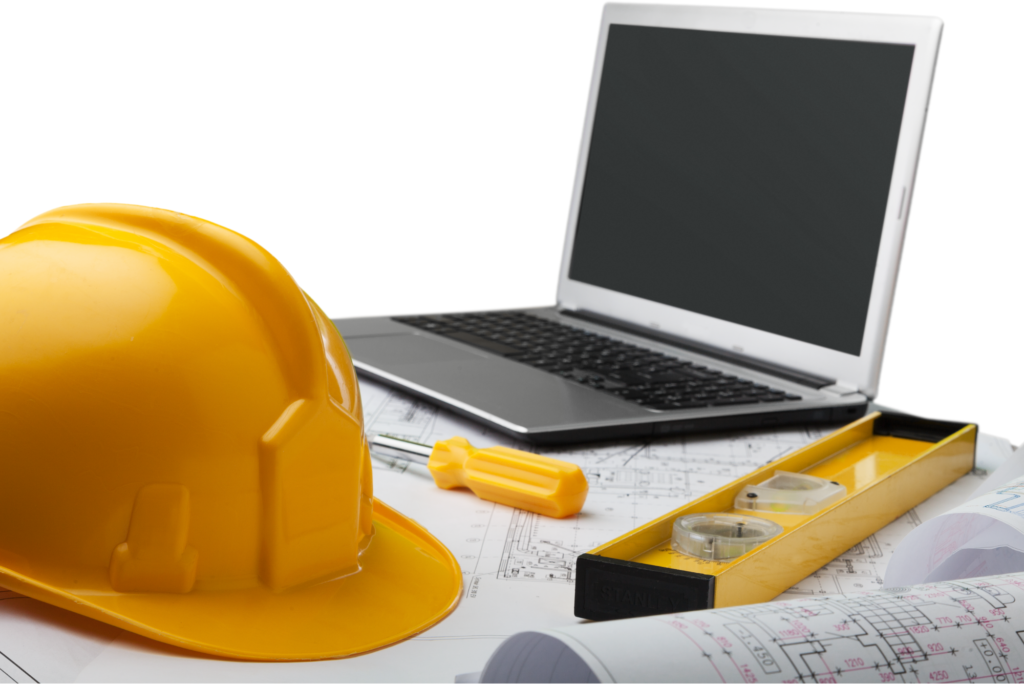 Laptop next to construction tools.