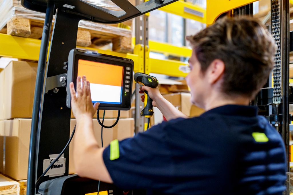 A forklift operator using a rugged vehicle-mounted computer.