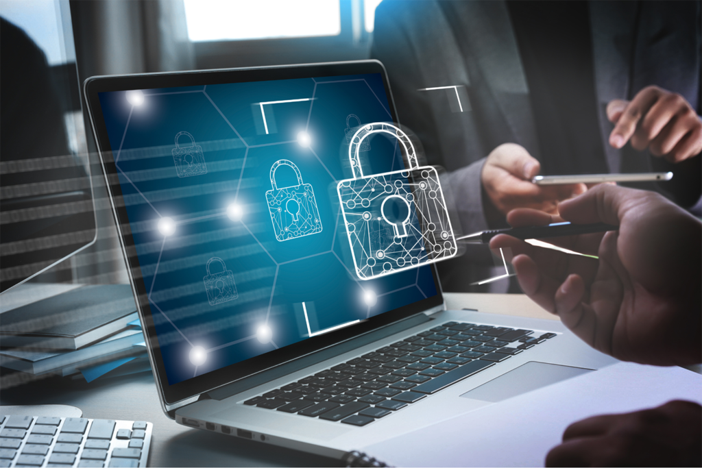 A worker on a laptop with a lock symbol coming out of the screen.